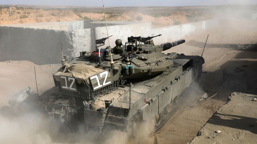Israeli soldiers from the Kfir brigade's Shimshon ("Samson") battalion ride in a Merkava battle tank during a military exercise at the Tzeelim army base on July 3, 2018 simulating urban combat in the Gaza Strip. (Photo by MENAHEM KAHANA / AFP) (Photo credit should read MENAHEM KAHANA/AFP via Getty Images)